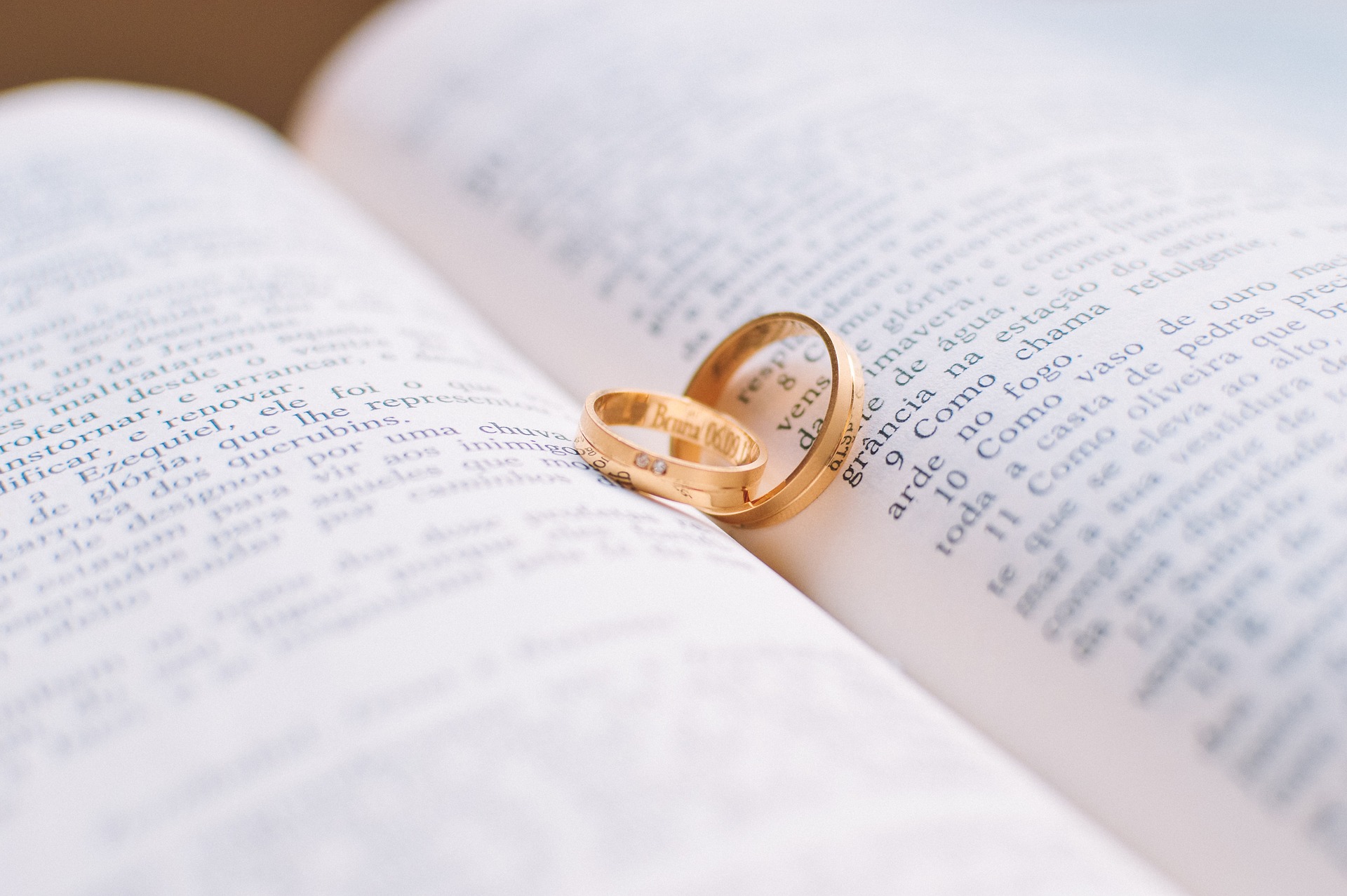 two wedding bands on an open book