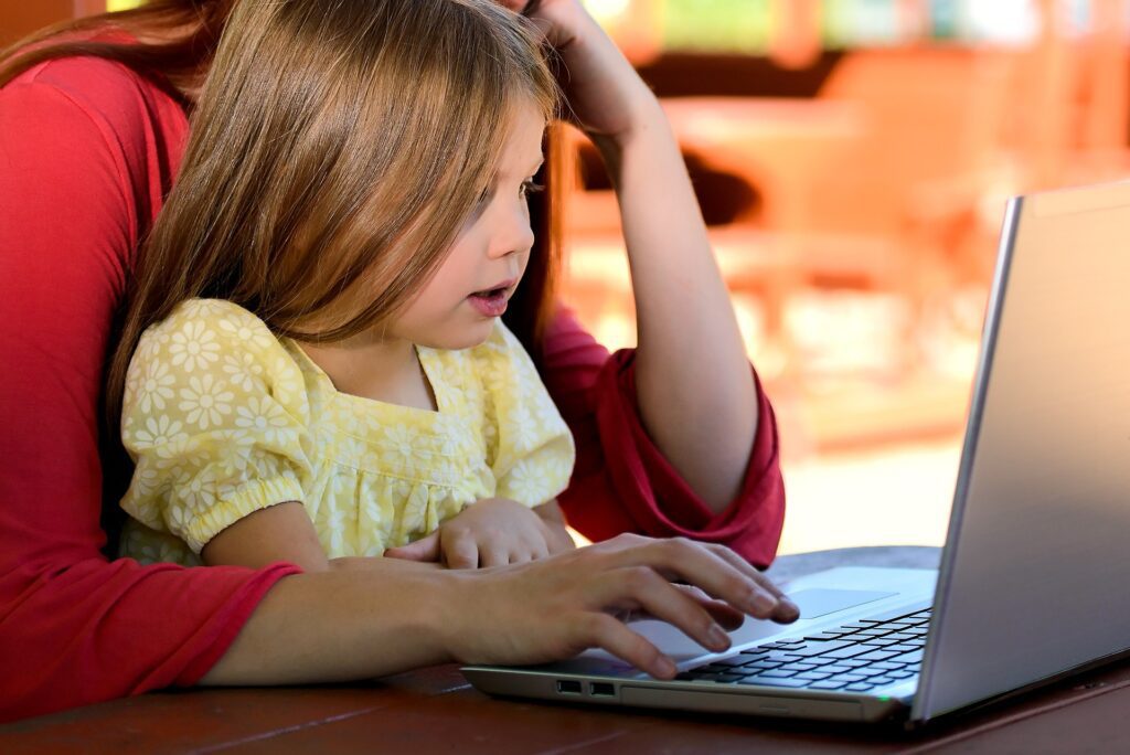 Mother working with child on lap